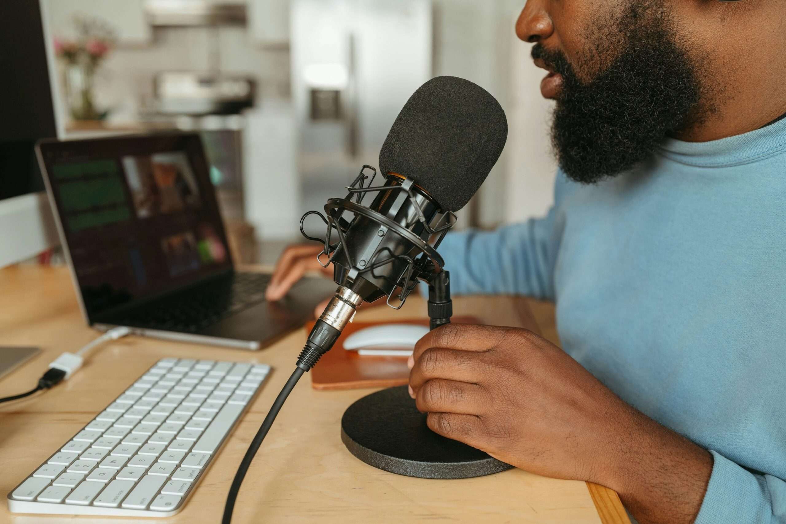 A podcast producer with a microphone managing some video files