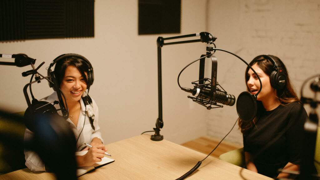Two ladies recording a podcast