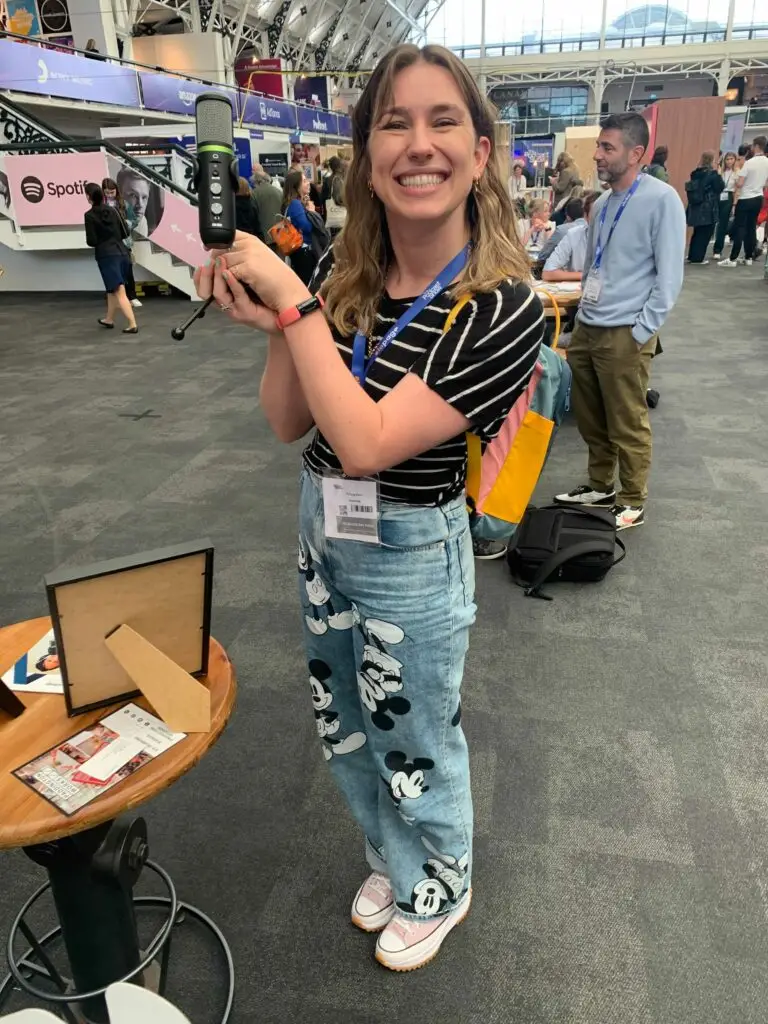 Podcaster and Voiceover artist, Tiffany Clare holding her giveaway prize