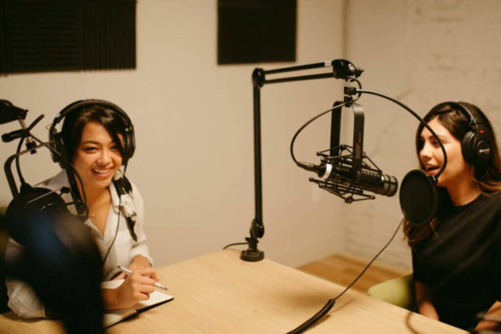 Two ladies recording a podcast