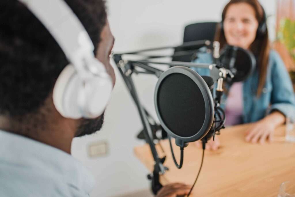 Man interviewing a woman for his podcast